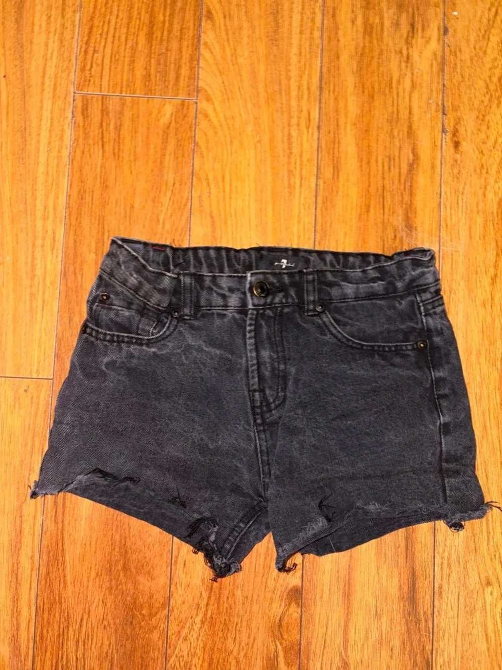 Black denim shorts with a distressed look